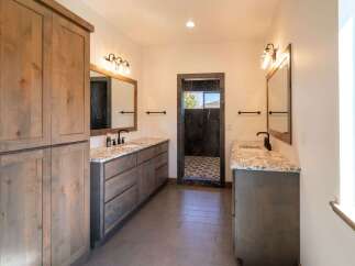 Step into luxury with this stunning bathroom featuring dual vanities and a spacious design.