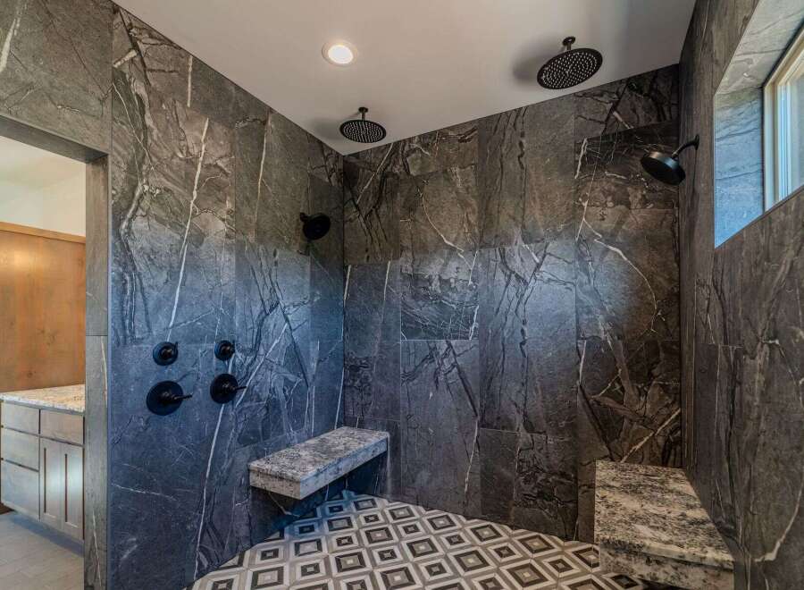 Step into luxury with this stunning bathroom featuring exquisite marble tile.
