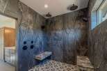 Step into luxury with this stunning bathroom featuring exquisite marble tile.