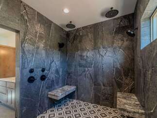 Step into luxury with this stunning bathroom featuring exquisite marble tile.