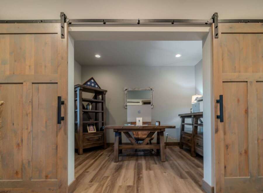 Step into a world of rustic elegance with this stunning property, featuring exquisite barn doors that lead to a home office.