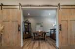 Step into a world of rustic elegance with this stunning property, featuring exquisite barn doors that lead to a home office.