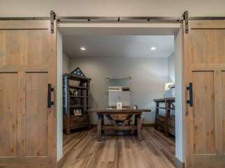 Step into a world of rustic elegance with this stunning property, featuring exquisite barn doors that lead to a home office.