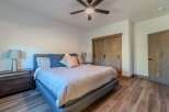 This inviting bedroom showcases a comfortable bed with stylish bedding and accent pillows.