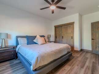This inviting bedroom showcases a comfortable bed with stylish bedding and accent pillows.