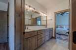 Step into luxury with this stunning bathroom featuring a double vanity and ample storage.
