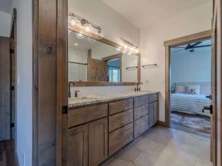 Step into luxury with this stunning bathroom featuring a double vanity and ample storage.