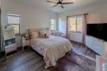This charming bedroom offers a cozy retreat with its plush bedding and inviting ambiance.