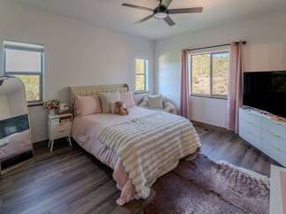This charming bedroom offers a cozy retreat with its plush bedding and inviting ambiance.