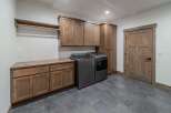 This stunning laundry room boasts a modern design with ample storage and functionality.