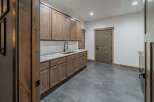 This stunning kitchen features custom wooden cabinetry, offering ample storage and a warm, inviting atmosphere.