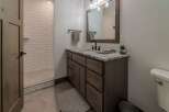 This stunning bathroom features a modern design with a beautiful vanity and a spacious shower.