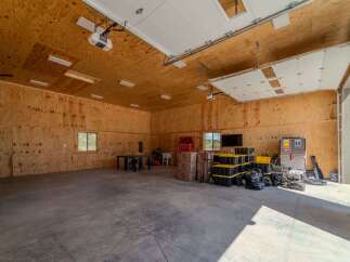 Spacious garage with ample storage and workspace.