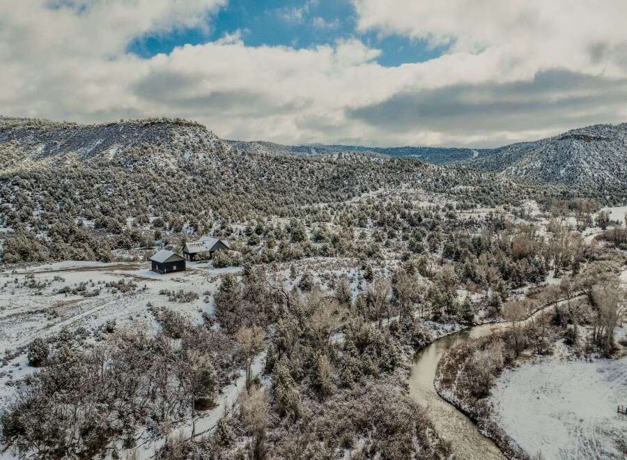 Nestled in a serene winter landscape, this property offers a unique blend of natural beauty and rustic charm.