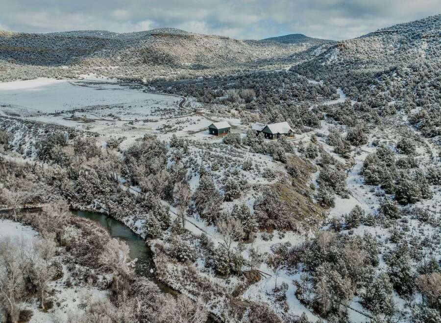 Nestled in a serene winter landscape, this property offers a unique blend of natural beauty and modern living.
