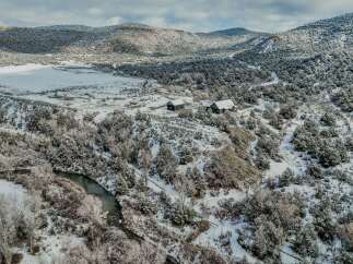 Nestled in a serene winter landscape, this property offers a unique blend of natural beauty and modern living.