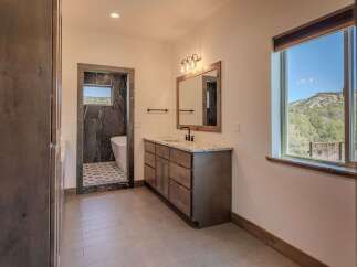 Step into luxury with this stunning bathroom, featuring a sleek vanity and a spa-like ambiance.