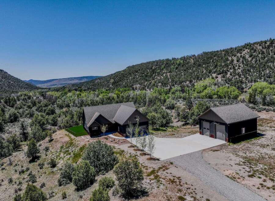 Experience luxury living in this stunning modern home nestled amidst breathtaking natural scenery.