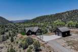 Experience luxury living in this stunning modern home nestled amidst breathtaking natural scenery.