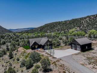 Experience luxury living in this stunning modern home nestled amidst breathtaking natural scenery.