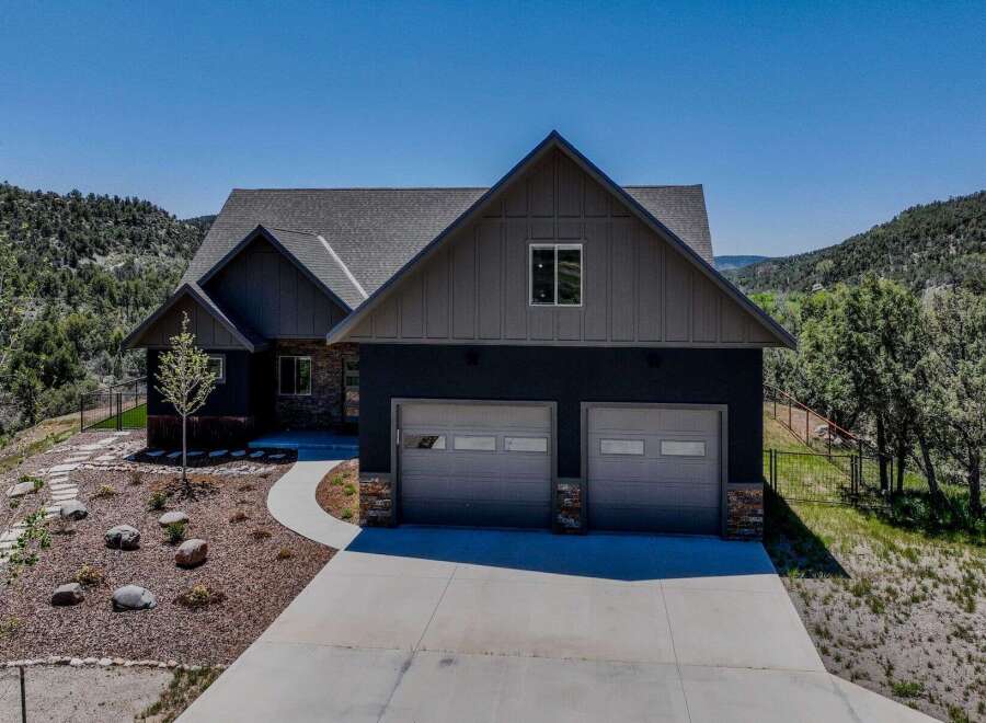 Discover this stunning modern home nestled in a picturesque mountain setting.