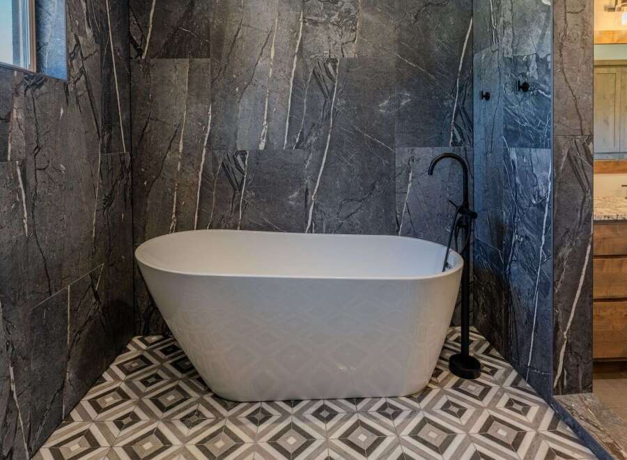 Experience ultimate relaxation in this luxurious bathroom featuring a stunning freestanding bathtub.