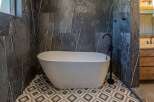 Experience ultimate relaxation in this luxurious bathroom featuring a stunning freestanding bathtub.