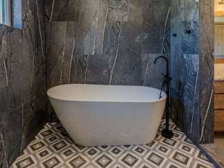 Experience ultimate relaxation in this luxurious bathroom featuring a stunning freestanding bathtub.