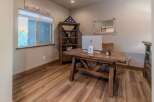 This home office features a rustic wooden desk with a modern Apple computer, perfect for productivity.