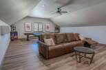 This spacious game room offers a perfect blend of entertainment and relaxation, featuring a full-size pool table and two classic arcade machines.