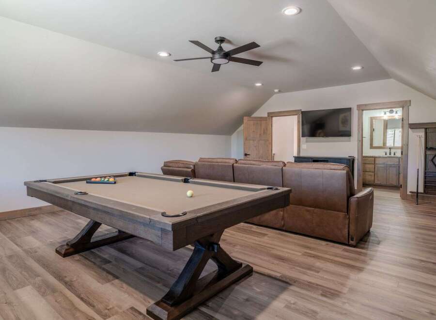 This spacious game room features a full-size pool table, perfect for friendly competitions.