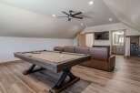This spacious game room features a full-size pool table, perfect for friendly competitions.