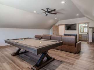 This spacious game room features a full-size pool table, perfect for friendly competitions.