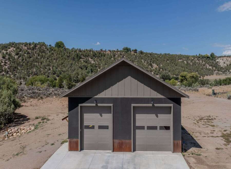 Discover this modern garage featuring two spacious bays, perfect for vehicle storage or a workshop.