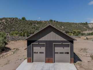 Discover this modern garage featuring two spacious bays, perfect for vehicle storage or a workshop.