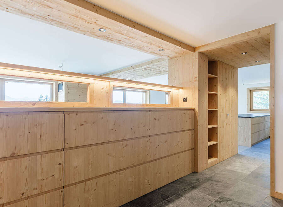 This stunning property boasts a modern design with natural wood elements throughout.