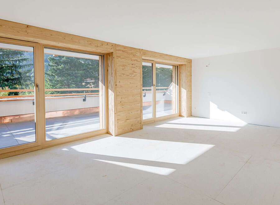 Discover the charm of this bright and airy living space, featuring stunning wooden accents and expansive windows.