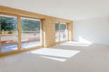 Discover the charm of this bright and airy living space, featuring stunning wooden accents and expansive windows.