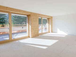 Discover the charm of this bright and airy living space, featuring stunning wooden accents and expansive windows.