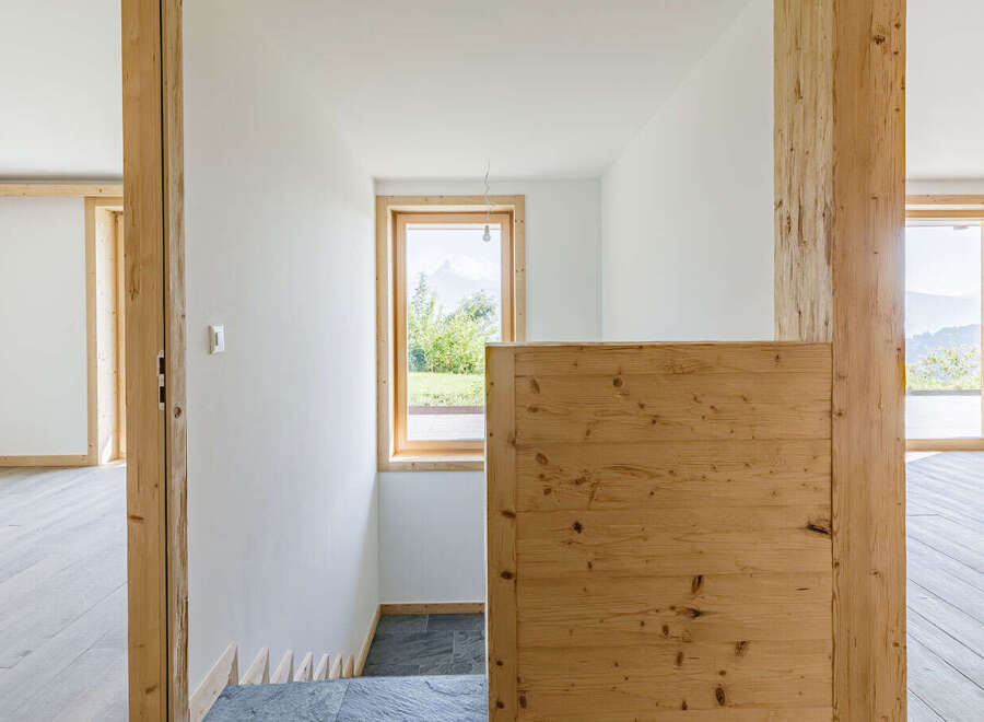This stunning property showcases a modern interior with natural wood accents and a bright, airy atmosphere.