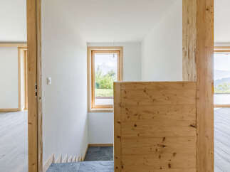 This stunning property showcases a modern interior with natural wood accents and a bright, airy atmosphere.