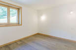 This bright and airy room features a large window that lets in plenty of natural light, creating a welcoming atmosphere.