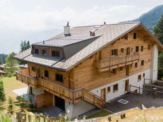 This stunning wooden chalet offers breathtaking mountain views and a serene escape.