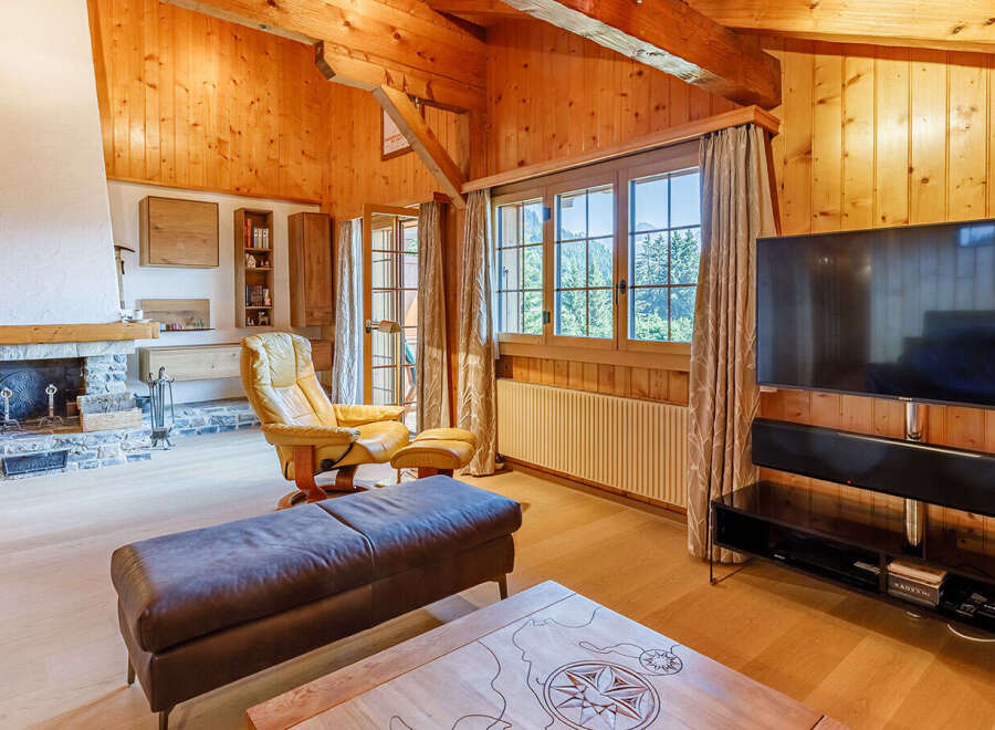 Experience the warmth of this stunning living space, featuring a cozy fireplace and beautiful wooden accents throughout.