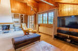 Experience the warmth of this stunning living space, featuring a cozy fireplace and beautiful wooden accents throughout.