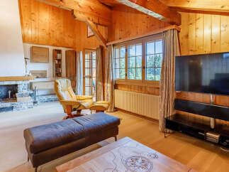 Experience the warmth of this stunning living space, featuring a cozy fireplace and beautiful wooden accents throughout.