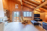 Experience the charm of this stunning chalet, featuring a cozy fireplace and exposed wooden beams that create a warm and inviting atmosphere.