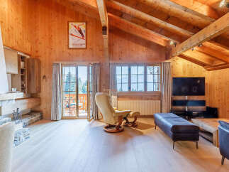 Experience the charm of this stunning chalet, featuring a cozy fireplace and exposed wooden beams that create a warm and inviting atmosphere.