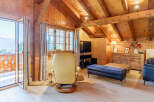 Experience the charm of this cozy chalet-style living space, featuring warm wooden accents and a vaulted ceiling.