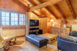 Experience the charm of this cozy living space, featuring a warm wooden interior and a stunning view from the large windows.